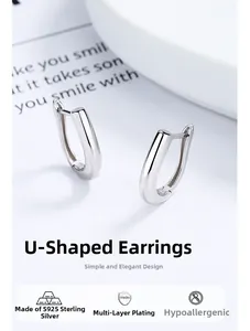 Macro shot of minimalist s925 sterling silver U-shaped hoop earrings with polished finish