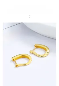 Close-up of polished 925 sterling silver U-shaped hoop earrings with S925 hallmark