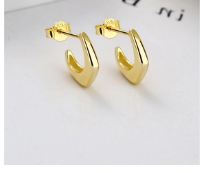 Detailed close-up of 925 sterling silver geometric C-shape hoop earrings with gold plating