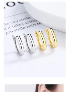 Macro view of minimalist U-shaped hoop earrings in gold and silver mirror finishes