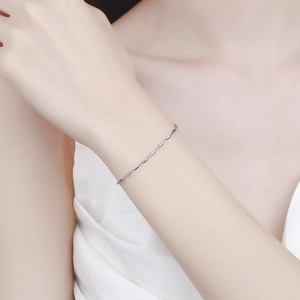 Minimalist 925 sterling silver cube chain bracelet on a female model wrist