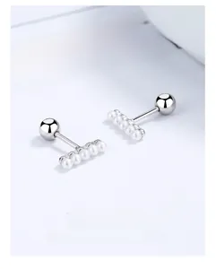 Detailed view of 925 sterling silver screw back earrings with five aligned white pearls