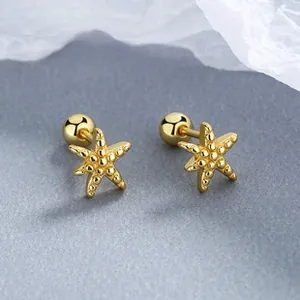 Detail of golden starfish stud earrings with realistic texture and screw ball back