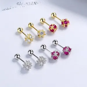 Macro shot of 925 silver heart stud earrings with round red and white zircon stones