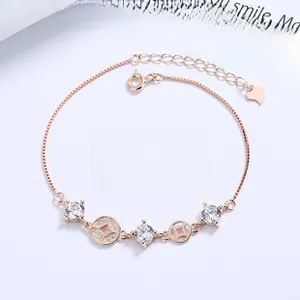 Detailed macro shot of rose gold coin bracelet with sparkling zirconia and heart charm