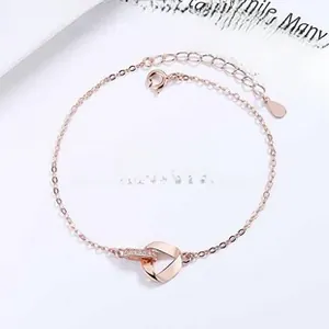 Detailed view of Mobius rose gold bracelet with crystal-paved interlocking circles