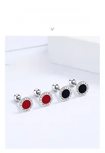 Macro shot of 925 sterling silver roman numeral earrings in red and black enamel
