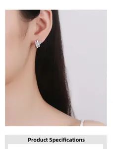 Close-up of a sparkling butterfly hoop earring in 925 sterling silver on a model ear