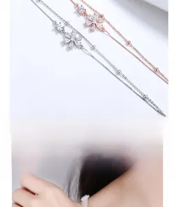 Detail of 925 silver cherry blossom bracelet with zircon inlay and double-layer chain