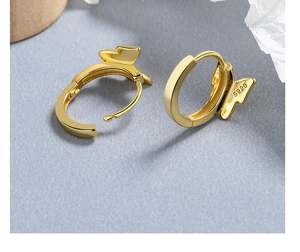 Close-up of S925 hallmark on gold butterfly hoop earrings with polished metal finish