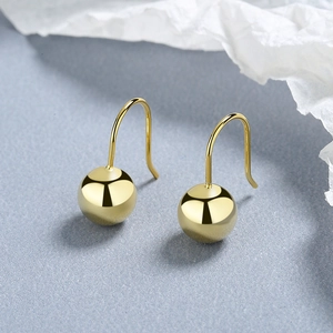 Polished gold metal ball hook earrings for women featuring a minimalist mirror finish