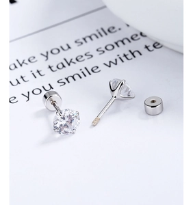 Detail of S925 sterling silver four-claw zircon earrings with secure screw-back design