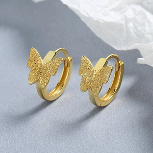 Elegant gold butterfly hoop earrings with sandblasted finish for a textured metallic look