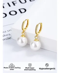 Macro shot of S925 sterling silver stamp on hypoallergenic gold pearl hoop earrings