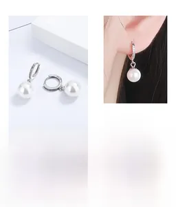 Detail of S925 sterling silver pearl hoop earrings with crystal pavé and 925 hallmark