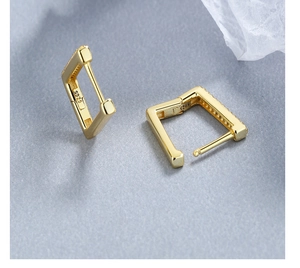 Macro detail of gold plated S925 sterling silver square earrings with inlaid zircon stones