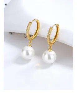 Close-up of S925 silver stamp on gold-plated pearl hoop earrings with zircon