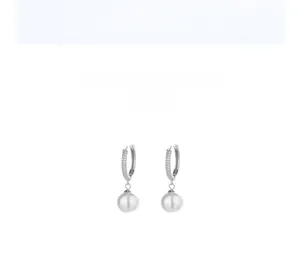 Detail showing elegant pearl drop earrings with sparkling micro-pave zircon crystals