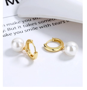 Detail shot of gold-plated hoop earrings with fine pavé stones and S925 silver stamp