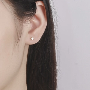 Minimalist 925 sterling silver cylindrical screw back stud earrings for women on earlobe