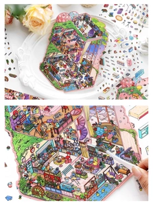 Vue macro d'un autocollant 2.5D de chambre miniature saisi avec une pince pour le bricolage