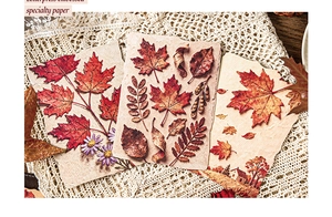 Nahaufnahme von geprägtem botanischem Papier mit Ahornblatt- und Blumentexturen
