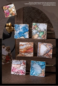 Close-up of vintage aesthetic art paper stickers featuring floral and mountain themes