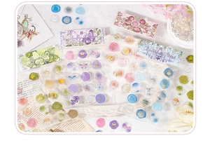 Flat lay of vintage wax seal stickers with floral patterns and wax beads on newspaper