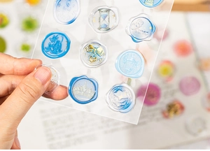 Detail of 3D crystal epoxy stickers with blue wax seal designs for DIY scrapbooking