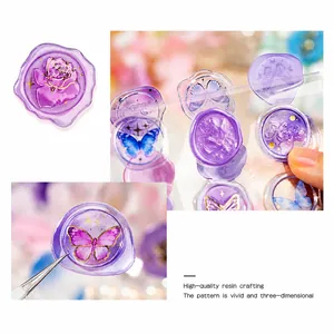 Macro detail of 3D embossed purple resin wax seal stickers with rose and butterfly motifs