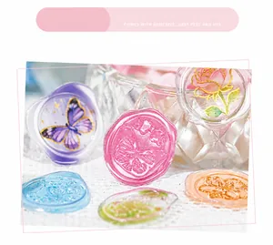 Detailed view of translucent floral wax seal stickers with adhesive on lace tablecloth