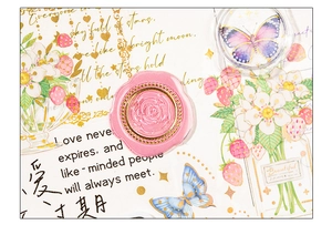 Detailed macro of vintage rose and butterfly wax seal stickers for scrapbooking