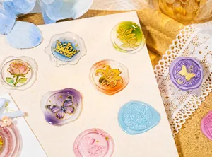 Detailed view of 3D wax seal stickers featuring floral embossed patterns with gold edges