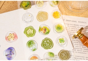 Detail showing vintage floral wax seal stickers with maple leaf and butterfly motifs