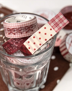 Detail of red and beige washi tape set featuring plaid, dots, and bow patterns for DIY