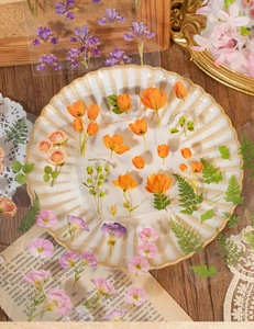 Close-up of vintage floral PET stickers with botanical patterns on a decorative plate