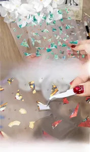 Detailed close-up of PET sticker peeling with tweezers showing waterproof texture