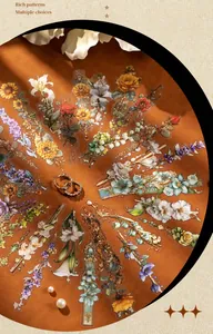 Detailed view of floral PET stickers with roses and lilies on premium orange satin fabric