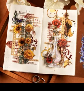 Detailed view of vintage floral stickers and butterfly motifs on a dot grid notebook
