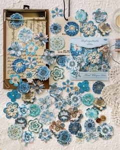 Flat lay of 50 vintage blue floral paper stickers with rose and daisy for scrapbooking