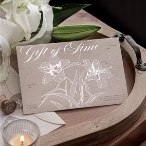 Vintage silver-foiled kraft paper envelope with artistic floral pattern and Gift of Time text