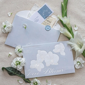 Light blue floral envelope set with silver foiled orchid patterns and wax seal decor
