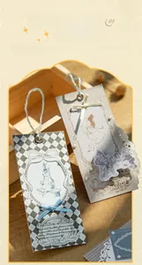 Vintage fairy tale paper bookmarks with rabbit illustration and elegant ribbons on wood