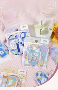 Macro detail of PET stained glass heart stickers with pastel colors on pink fabric