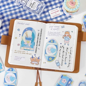 Brown leather journal with stained glass stickers and floral illustrations on grid paper