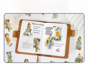 Detail of vintage character stickers on a brown grid notebook with leather cover
