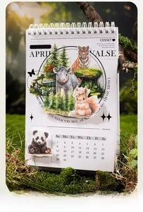 Close-up of animal stickers on a white spiral calendar with panda and forest-themed motifs