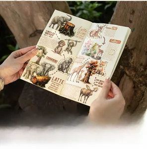 Detailed hand-drawn animal stickers featuring wildlife motifs on a scrapbook in a forest