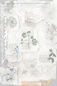 Detailed view of vintage botanical scrapbooking stickers with floral and stamp motifs