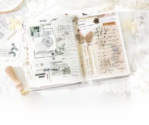Macro shot of vintage botanical PET stickers and floral labels for junk journal DIY